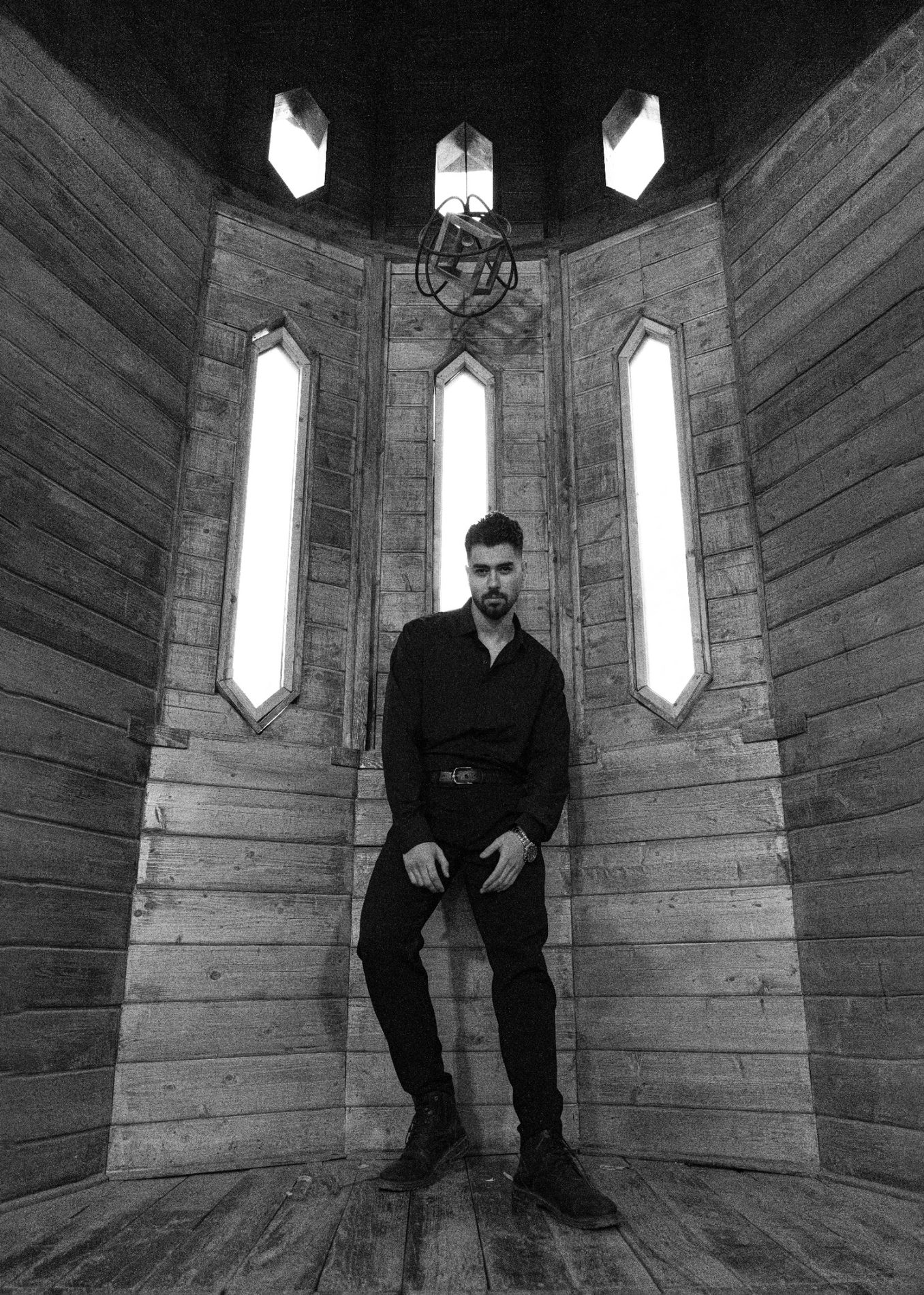 Black and white cinematic portrait in wooden interior